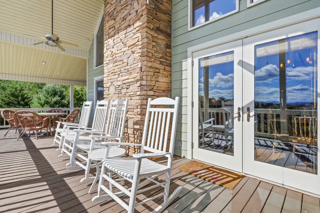 Covered porch with white rocking chairs and French doors at Peace of Tranquility, Blue Ridge GA